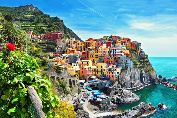 Manarola, Cinque Terre - train station in small village with colorful houses on cliff overlooking sea. Cinque Terre National Park with rugged coastline is famous tourist destination in Liguria, Italy