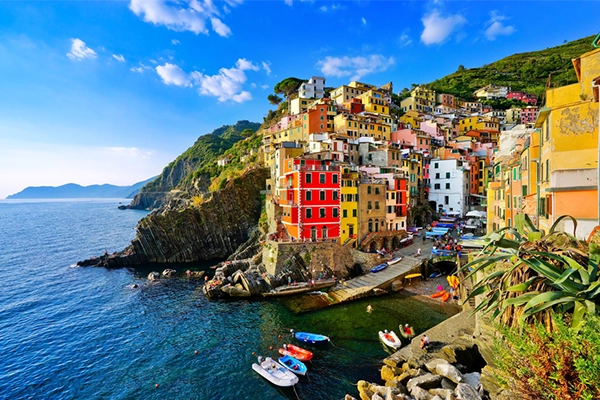 View of the colorful houses along the coastline of Cinque Terre area in Riomaggiore, Italy.