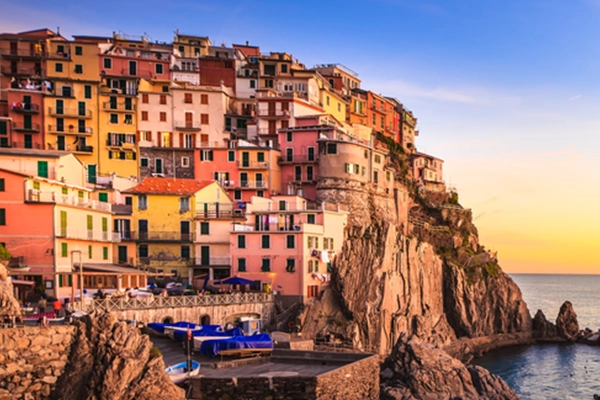 Manarola village on cliff rocks and sea at sunset., Seascape in Five lands, Cinque Terre National Park, Liguria Italy Europe. Long Exposure Photography.