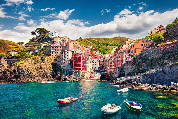 First city of the Cique Terre sequence of hill cities - Riomaggiore. Colorful morning view of Liguria, Italy, Europe. Great spring seascape of Mediterranean sea. Traveling concept background.