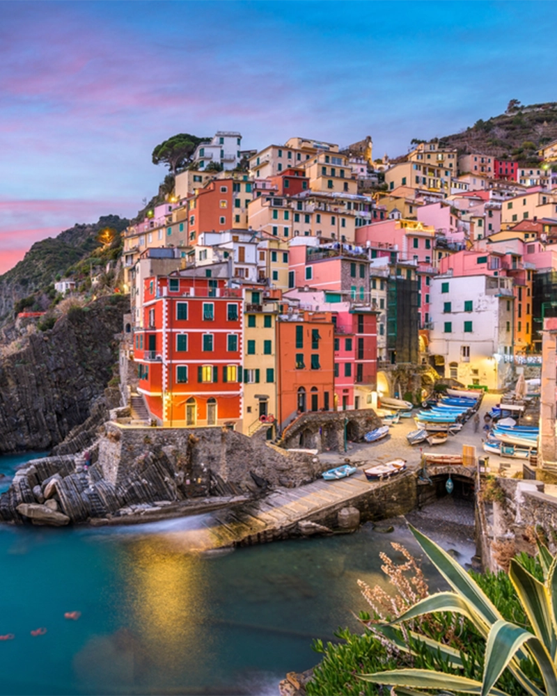 Riomaggiore, Italy, in the Cinque Terre coastal area at dusk.