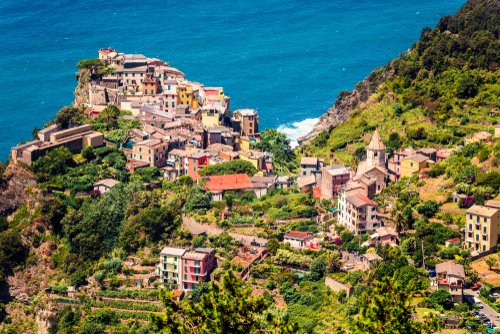 Third village of the Cique Terre sequence of hill cities - Corniglia. Sunny spring morning in Liguria, Italy, Europe. Picturesqie seascape of Mediterranean sea. Traveling concept background.