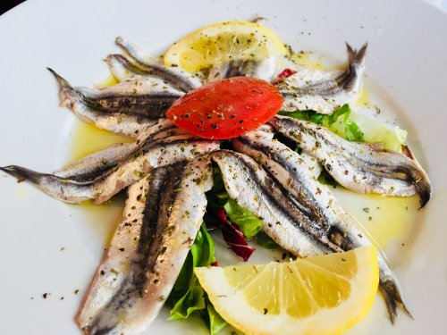 Acciughe al limone. Tasty fresh fish with lemon and olive oil. Typical, anchovy, dish, italian food. (Cinque Terre, Five Lands, La Spezia, Liguria, Riviera, Italy)