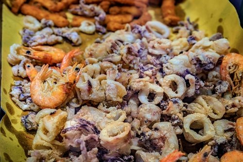 Fritto misto, Italian street food mix of fried calamari and shrimp for sale at a fast food joint in Riomaggiore, Cinque Terre Italy